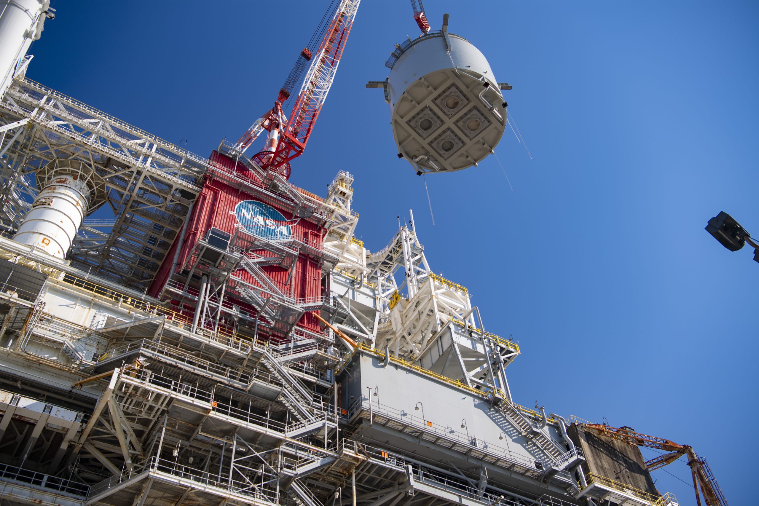 interstage simulator component suspended in air by crane